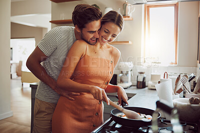 Buy stock photo Happy, loving and cooking couple bonding and having fun while spending time together at home. Playful, fun and smilinghusband and wife hugging while preparing a meal and sharing a romantic moment