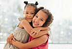 Cute, adorable and sweet young girls bond and hug with a happy and healthy childhood growing at home. Portrait of innocent and loving sisters with a bright smile, affection and relaxing in the house