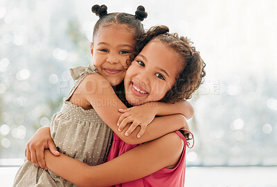 Buy stock photo Cute, adorable and sweet girls hugging and bond with a happy and healthy childhood growing at home. Portrait of innocent and loving sisters with a bright smile, affection and relaxing in the house