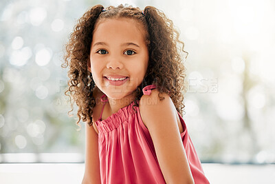 Buy stock photo Cute, adorable and sweet young girl with a happy and healthy childhood growing up at home. Portrait of an innocent young female child with a bright smile and relaxing in the house