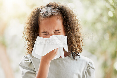 Buy stock photo Sick little girl with a flu, blowing her nose and looking uncomfortable. Child suffering with sinus, allergies or covid symptoms and feeling unwell. Kid with a cold sneezing and holding a tissue