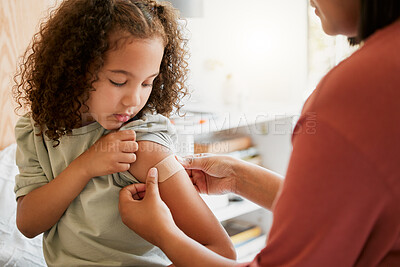 Buy stock photo Covid nurse vaccinating child putting a bandage on at a clinic. Doctor applying plaster on girl after an injection at health centre. Pediatric, immunity and prevention at medical children's hospital
