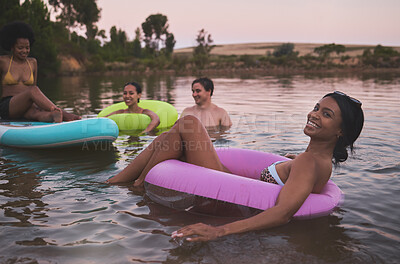 Buy stock photo Vacation, swimming and friendship having fun in a lake while enjoying the summer sunset. Happy friends relaxing and floating in water while talking and bonding on a getaway holiday