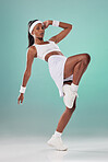 Fit, athletic and cute female tennis player or athlete woman with a cool attitude stretching in a green studio. Portrait of an active, trendy and sporty lady ready for training or a match