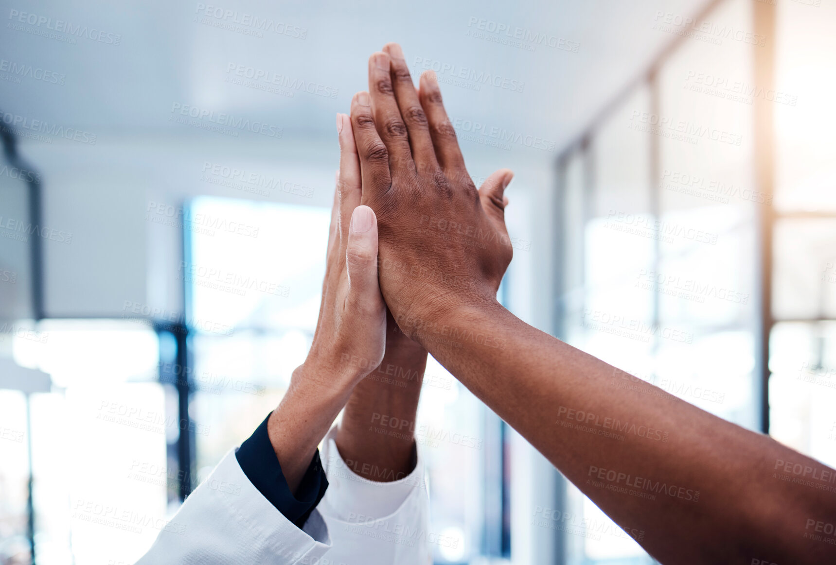 Buy stock photo High five, success and doctors celebrating teamwork, medical collaboration and support in a hospital. Closeup of healthcare hands joining in a huddle for winning achievement, motivation and victory