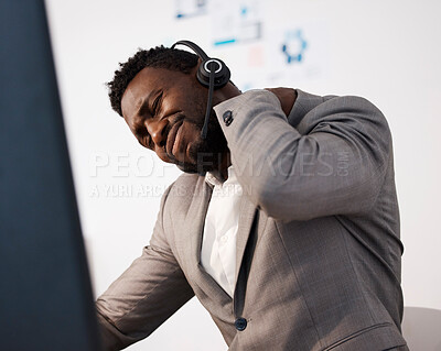 Buy stock photo Stressed, pain and tired call center agent with a shoulder injury feeling unhappy and overworked in the office. Young male customer service consultant with suffering from a painful neck