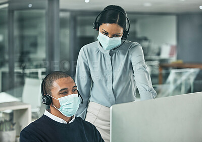Buy stock photo Covid, support and training while a manager is coaching a call center agent wearing a face mask. Collaboration, leadership and teamwork in telemarketing agency while looking at computer screen