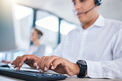 Buy stock photo Call center agent hands or CRM consultant typing client information on PC keyboard while talking on phone with headset. Contact us for customer service or telemarketing hotline support assistance.