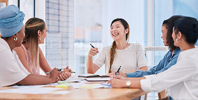 Buy stock photo A diverse business team of females only in a meeting laughing and smiling due to a positive mindset, mission and vision. Group of happy and excited businesswomen planning in a boardroom