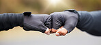 Motivation, teamwork and unity with hands in gloves fist bumping to show collaboration, solidarity and working together. Closeup of people showing success, community and achieving a goal as a team