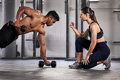 Training, exercise and motivation with a fitness coach or personal trainer and her bodybuilder student during a workout in the gym. Health, sports and wellness with a heathy athlete exercising