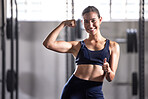 Strong, fit and thumbs up gesture of a successful woman in a healthy muscular body at a gym. Portrait of a happy, smiling and active female in fitness, strength and muscle at a health club.