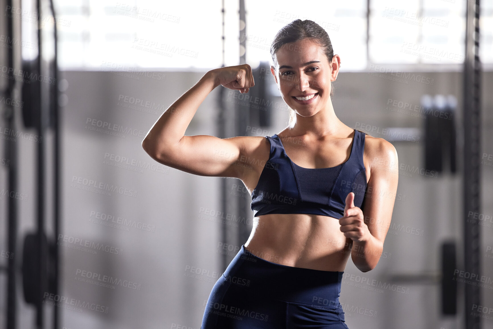 Buy stock photo Strong, fit and thumbs up sign of a successful woman in a healthy muscular body at a gym. Portrait of a happy, smiling and active female in fitness, strength and muscle at a health club.