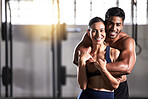 Strong, active and wellness couple looking fit and healthy after workout training session in a gym. Young sexy, attractive and athletic boyfriend and girlfriend embracing after reaching fitness goal
