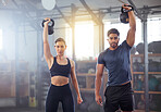 Fitness couple doing a kettlebell workout, exercise or training in a gym. Fit sports people, woman or man with a strong grip, exercising using gyming equipment to build muscles and forearm strength