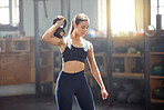 Kettlebell training, exercise and gym fitness for strong, fit and active woman doing weight workout, sport and wellness challenge in a sports club. Healthy, toned and slim female athlete exercising