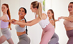 Yoga instructor, group training and pilates class for women in fitness, exercise and training studio. Yogi helping correct body form, posture and warrior pose for healthy lifestyle and flexible body
