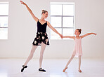 Ballerina, ballet and dance teacher with a child teaching beautiful, elegant and classical choreography in studio. Woman, professional and artist showing little girl graceful routine in pointe shoes
