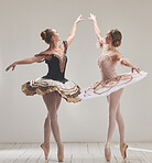 Ballerina, ballet dancer and creative performance, training rehearsal and choreography with en pointe technique on toes in dance studio. Graceful, elegant and beautiful women dancing in tutu costume

