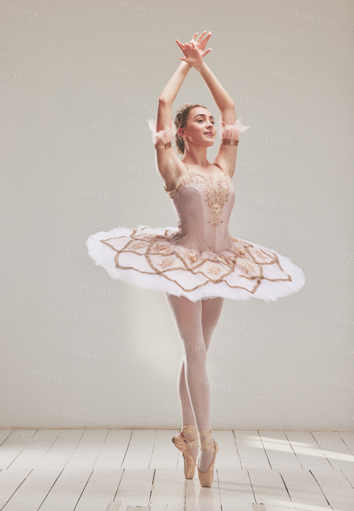 Buy stock photo Female ballerina doing ballet dance, dancing or performing during a practice rehearsal in studio. Young dancer or artist in a tutu costume dress and shoes doing pointe technique on toes performance