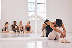 Bullying, stress or sad ballerina in training with ballet dancers, artists or professional studio performers. Upset, unhappy or anxious girl with bad mental health from bullying in theater rehearsal