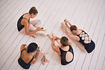 Ballet, fitness and active ballerina dancer stretching on floor, getting ready for rehearsal in dance studio. Above females bonding and relaxing, taking a break before a classic, elegant performance 
