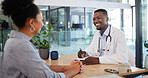 Doctors appointment of a woman patient consulting a doctor in a hospital office. Happy working medical and healthcare worker work with a smile talking about insurance, wellness and health success