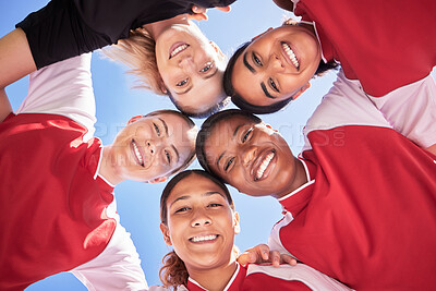 Buy stock photo Female soccer team huddle bonding, smiling or motivated in circle with heads in middle. Below portrait of fit, active and diverse group of football girls, friends or athletes at sports, match or game