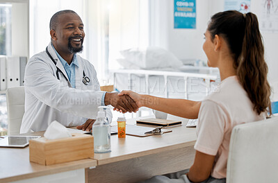 Buy stock photo Healthcare, insurance and handshake between a doctor and patient consulting in an office, discussing a treatment plan. Happy woman smiling, satisfied with expert advice from health care professional