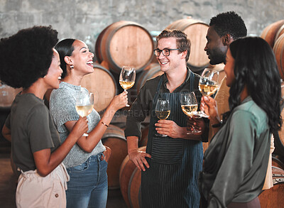 Buy stock photo Group of friends wine tasting at a distillery or cellar drinking glasses and enjoying the tour together. Happy, carefree and diverse people bonding and having fun at a winery estate