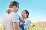 Laughing, in love and happy interracial couple in hug, embrace or holding each other on wine tasting farm. Fun, playful or loving man and woman standing close and enjoying countryside vineyard estate