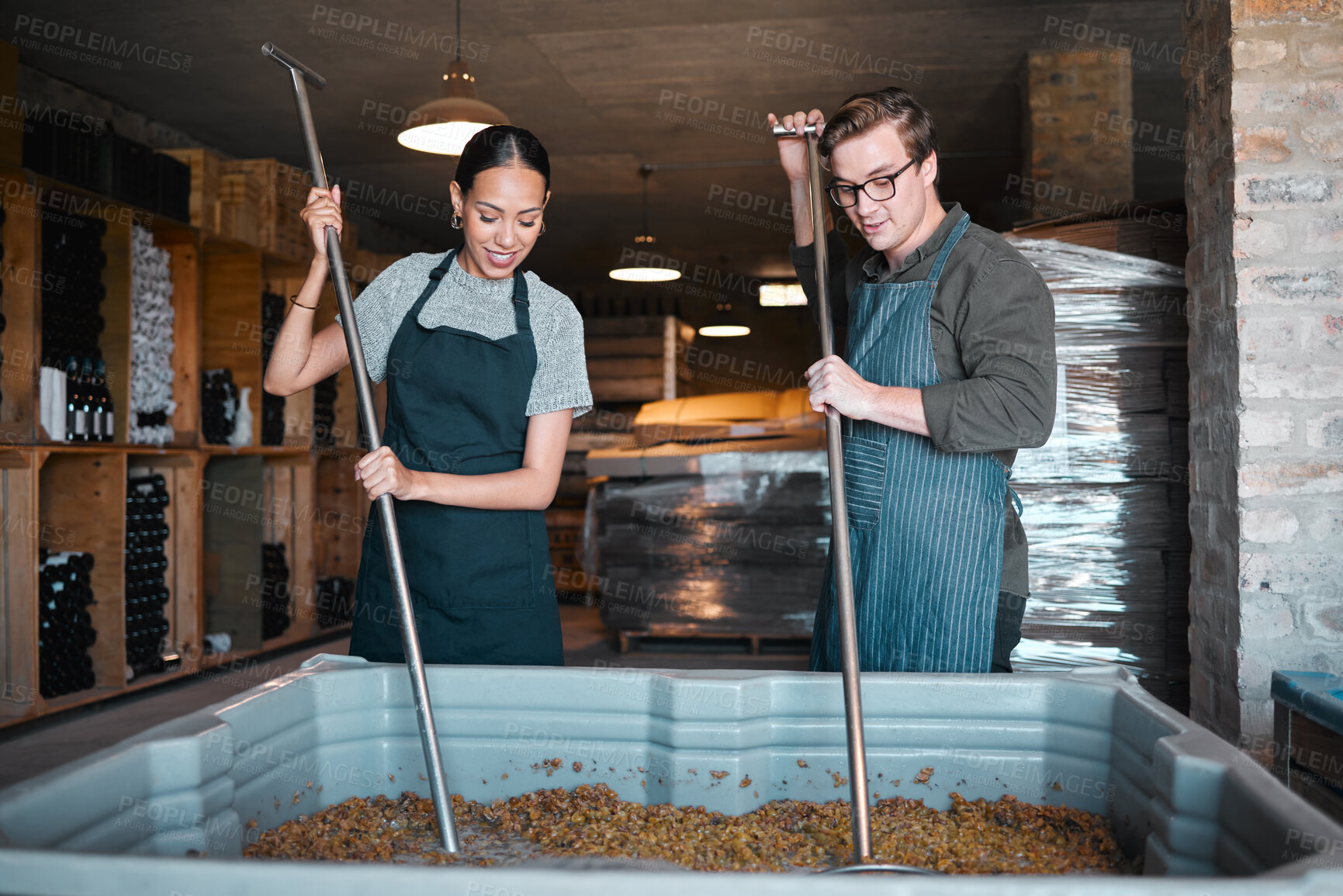 Buy stock photo Production, manufacturing worker and teamwork in wine industry and labor press tool for fermentation of grape fruit alcohol. Sommelier people working in winery, distillery or warehouse at a vineyard