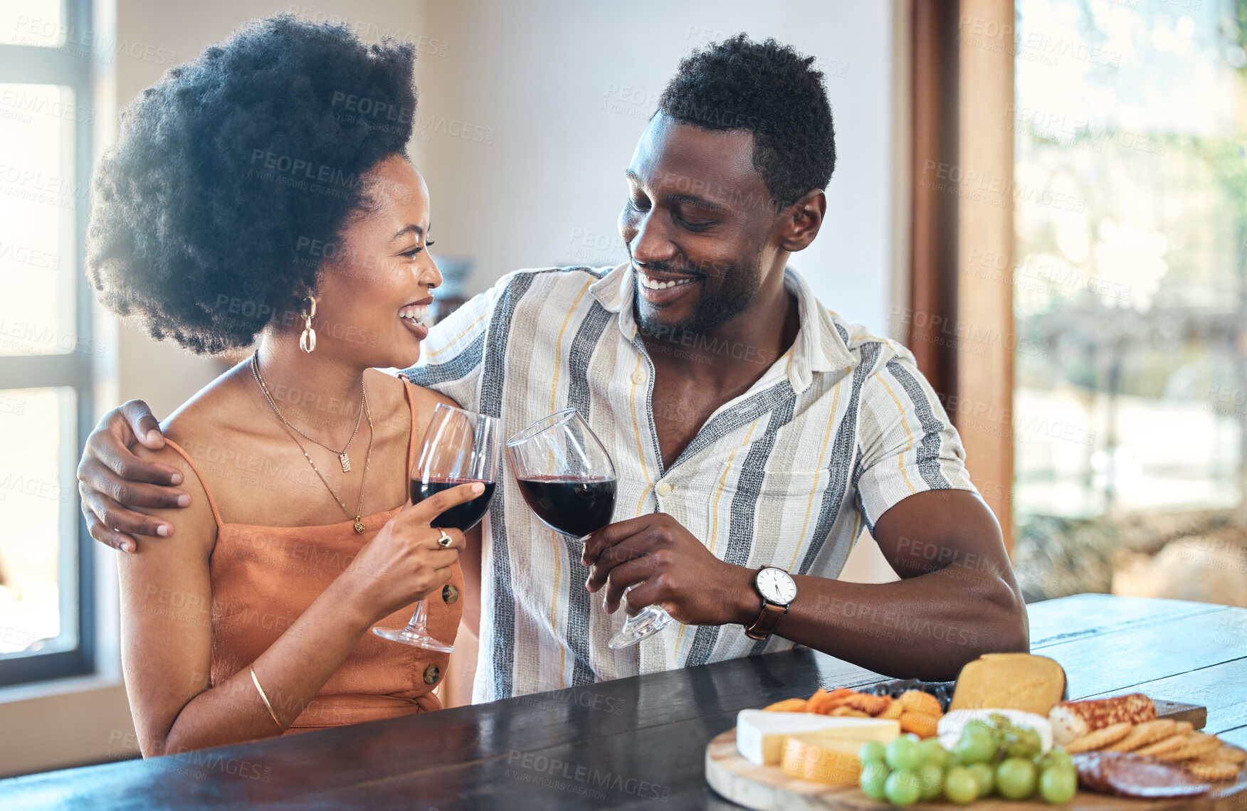Buy stock photo Young couple celebrating with wine and cheers at resort, laugh and bonding on romantic date. Carefree, in love black girlfriend and boyfriend toasting, enjoying relationship, alcohol and conversation