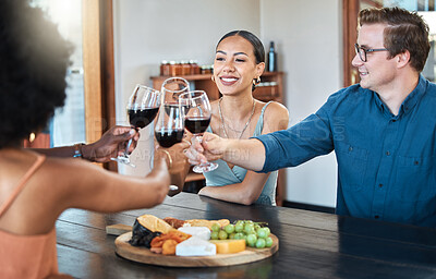 Buy stock photo Friends, fun and celebration with diverse group toasting with red wine to good news, bonding at a restaurant. Young friends reunion, happy to be together and enjoy wine tasting with charcuterie board
