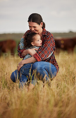 Buy stock photo Love, family and care with a mother and daughter hugging in a field outside on a farm. Cattle farmer and little girl in the farming, agricultural and dairy industry on a meadow or pasture outdoors
