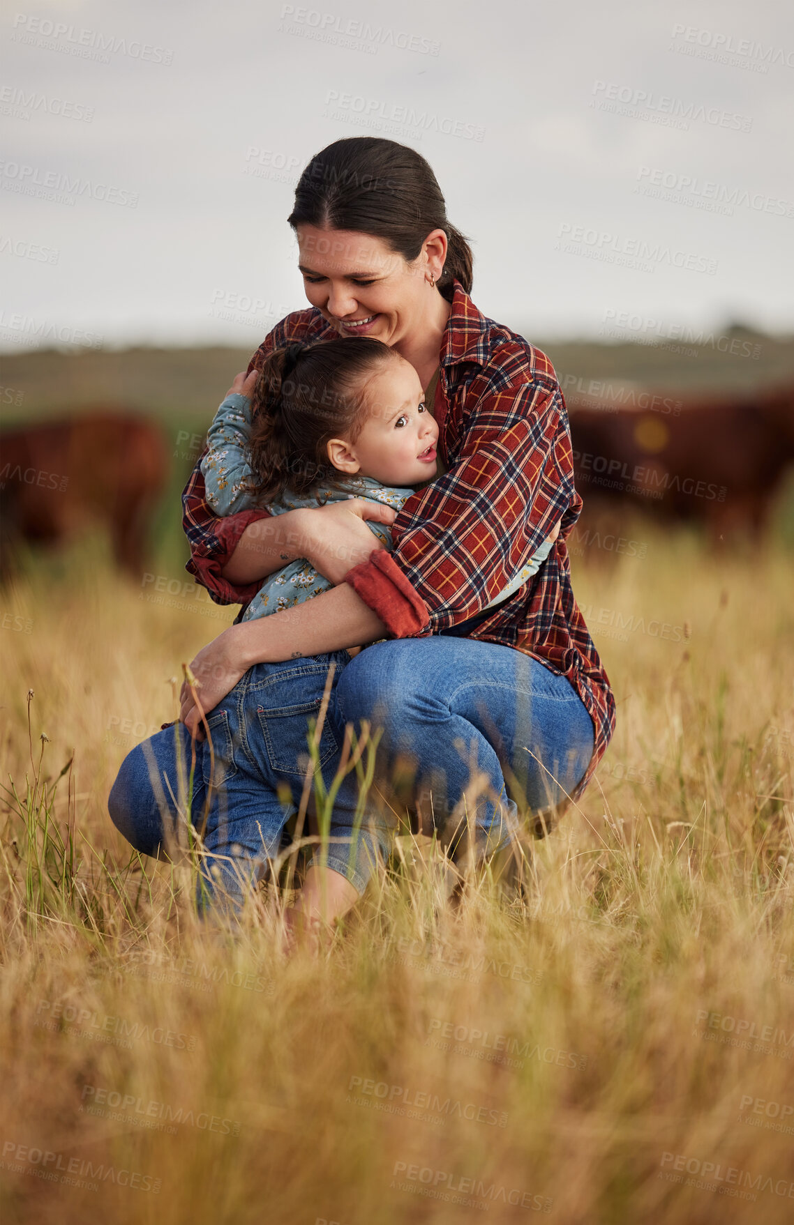 Buy stock photo Love, family and care with a mother and daughter hugging in a field outside on a farm. Cattle farmer and little girl in the farming, agricultural and dairy industry on a meadow or pasture outdoors