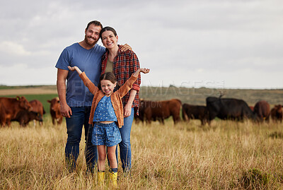 Buy stock photo Happy family standing on a farm, cow in background and with a vision for growth in industry portrait. Countryside couple, people or farmer in a field of grass, cattle and free range livestock animals