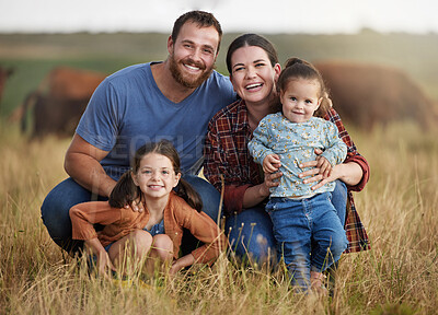 Buy stock photo Portrait of happy family on a countryside farm field with cows in the background. Farmer parents bonding with kids on a sustainable agriculture cattle business with a smile and happiness together