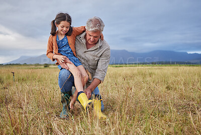 Buy stock photo Happy family bonding on farm grandparent and girl having fun in nature, prepare for walk together. Smiling child and caring grandfather exploring outdoors, enjoying a walk in the countryside or field