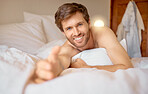 Man reaching out hand in bed, sleeping in bedroom on vacation and being lazy on weekend. Portrait of male person with smile taking nap alone, model going to sleep at night and relaxing in morning