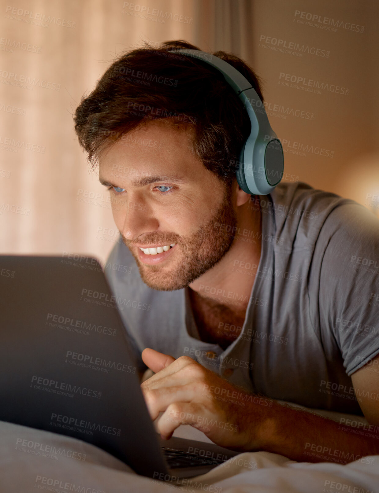 Buy stock photo Laptop, online tv and movie subscription with headphones late at night in his bedroom. Man with insomnia distracted with steaming internet to watch film, esports or enjoy gaming to relax at home