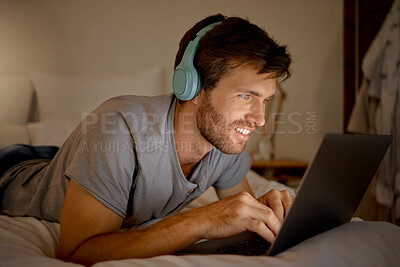 Buy stock photo Laptop, video and man streaming a movie in his bedroom on tv via internet while relaxed, smile and enjoying content. Headphones, house and happy male watching series on computer pc at night at home