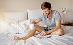 Writing, bed reading and happy man with coffee with his gratitude dairy or motivation journal. Guy with a smile relax at his house bedroom in peace with a positive mindset to start the day at home