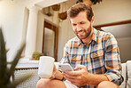 Phone, coffee and communication with a man on a social media app and mobile technology at home. Tea, relax and internet with a young male reading and typing a message while sitting in the living room