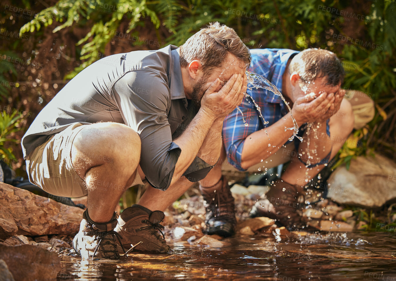 Buy stock photo Hiking men splash water on face for calm, relax and cleaning dirt after trekking on rock or hike in countryside forest. Earth, freedom after camping in nature and travel along mountain river or lake