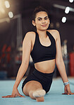 Dance or gymnastics stretching, sports health exercise and split training before a fitness workout. Portrait of a young woman gymnast or dancer before a sport performance or competition at a gym