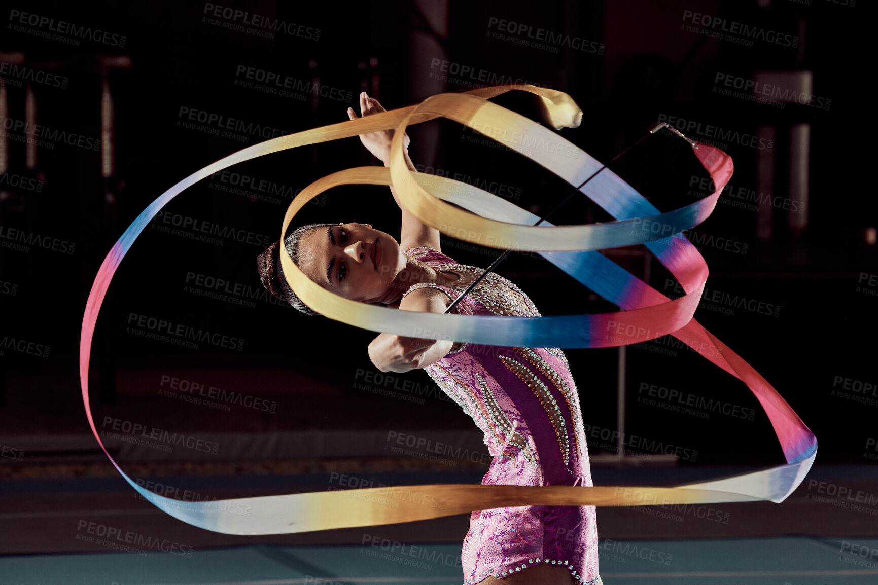 Buy stock photo Woman dancing with ribbon in concert in arena, dancer doing creative, artistic and cardio dance and training a performance in dark studio. Girl gymnast doing sport workout and strong in competition