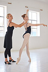Coach training a ballet dancer in studio, girl learning a dance performance with teacher in class and woman teaching creative dancing in room. Happy ballerina with smile in uniform at school