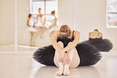 Buy stock photo Ballet, depression and sad ballerina girl after theatre practice, dance rehearsal or performance in a dancing hall or studio. Tired, bullying and stress of professional dancer sitting crying on floor