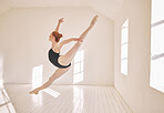Ballet, jump and performance dance studio with young student. Dancer girl with energy in isolated classroom and moving in the air. Beautiful woman ballerina with strong body and stunning posture.